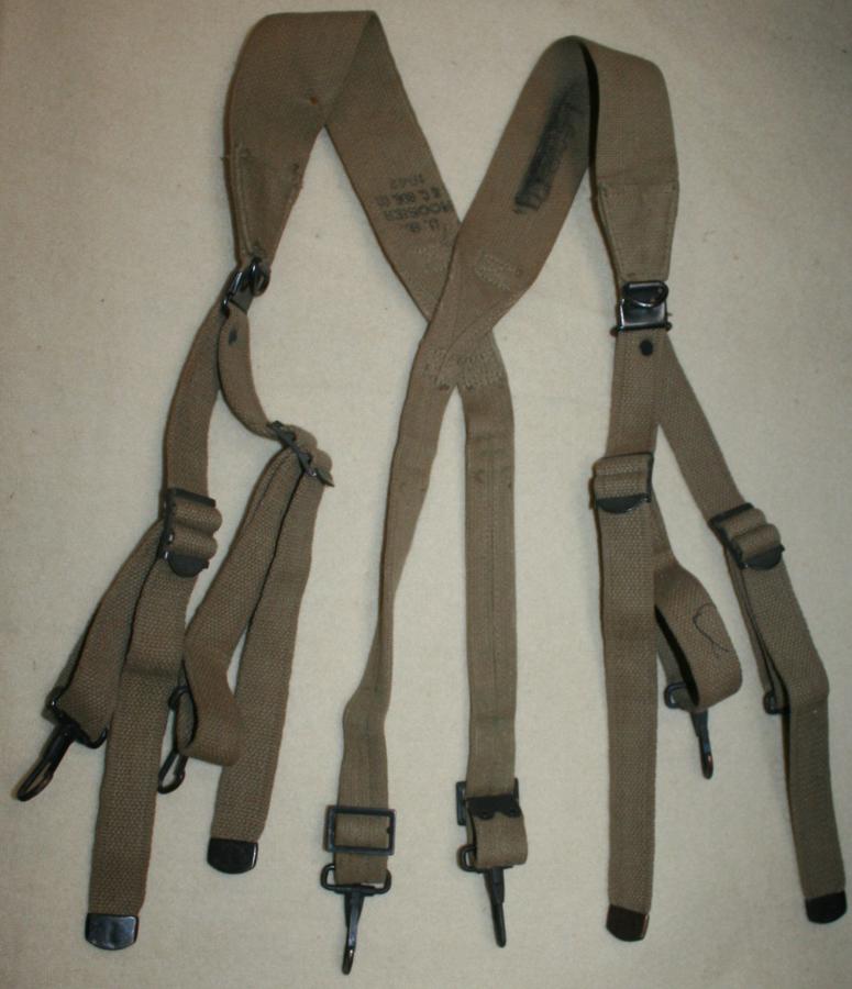 A GOOD USED PAIR OF M1928 SUSPENDERS 1942 DATED