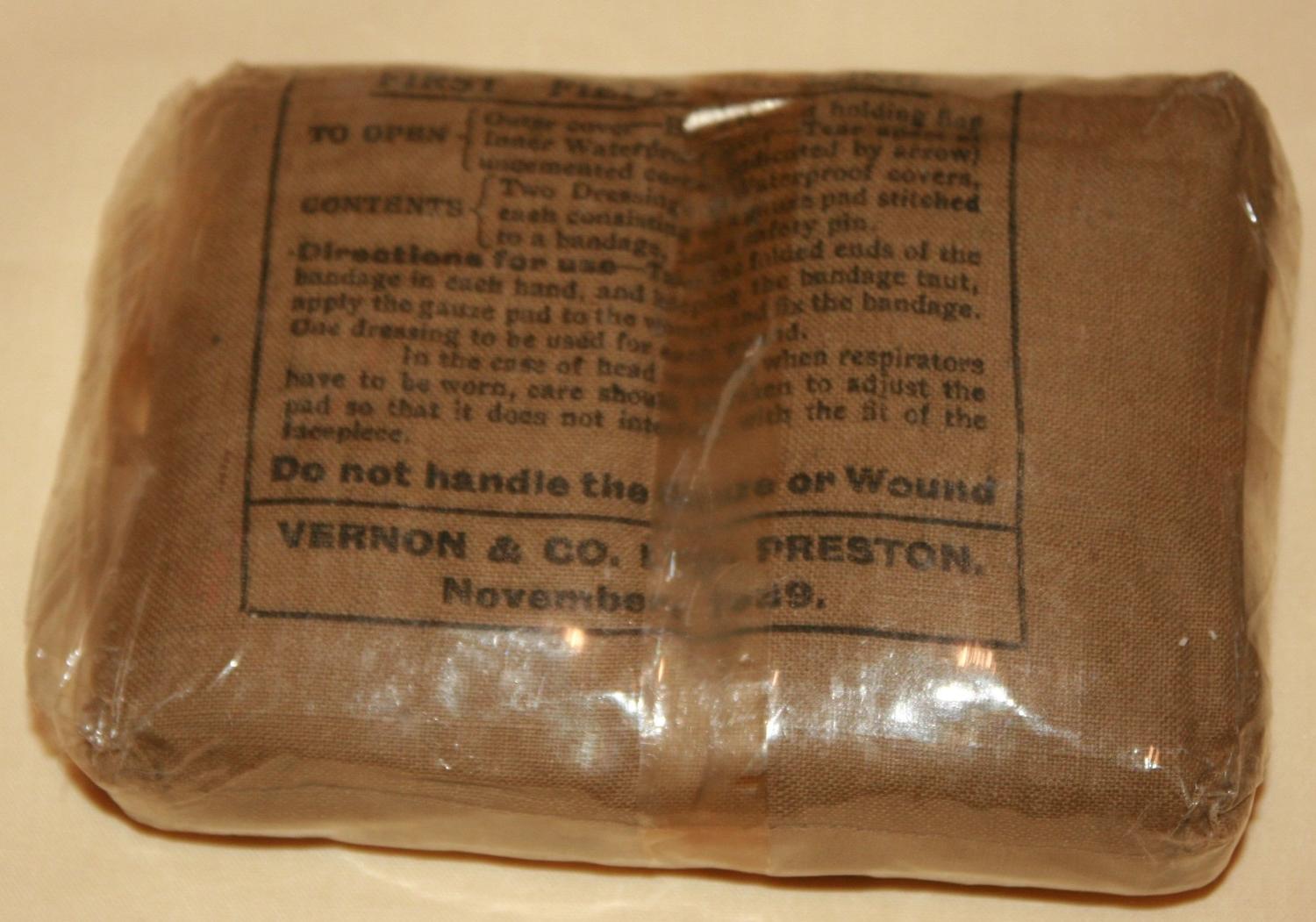 A 1939 DATED 1ST FILED DRESSING IN ITS CELLOPHANE WRAPPER