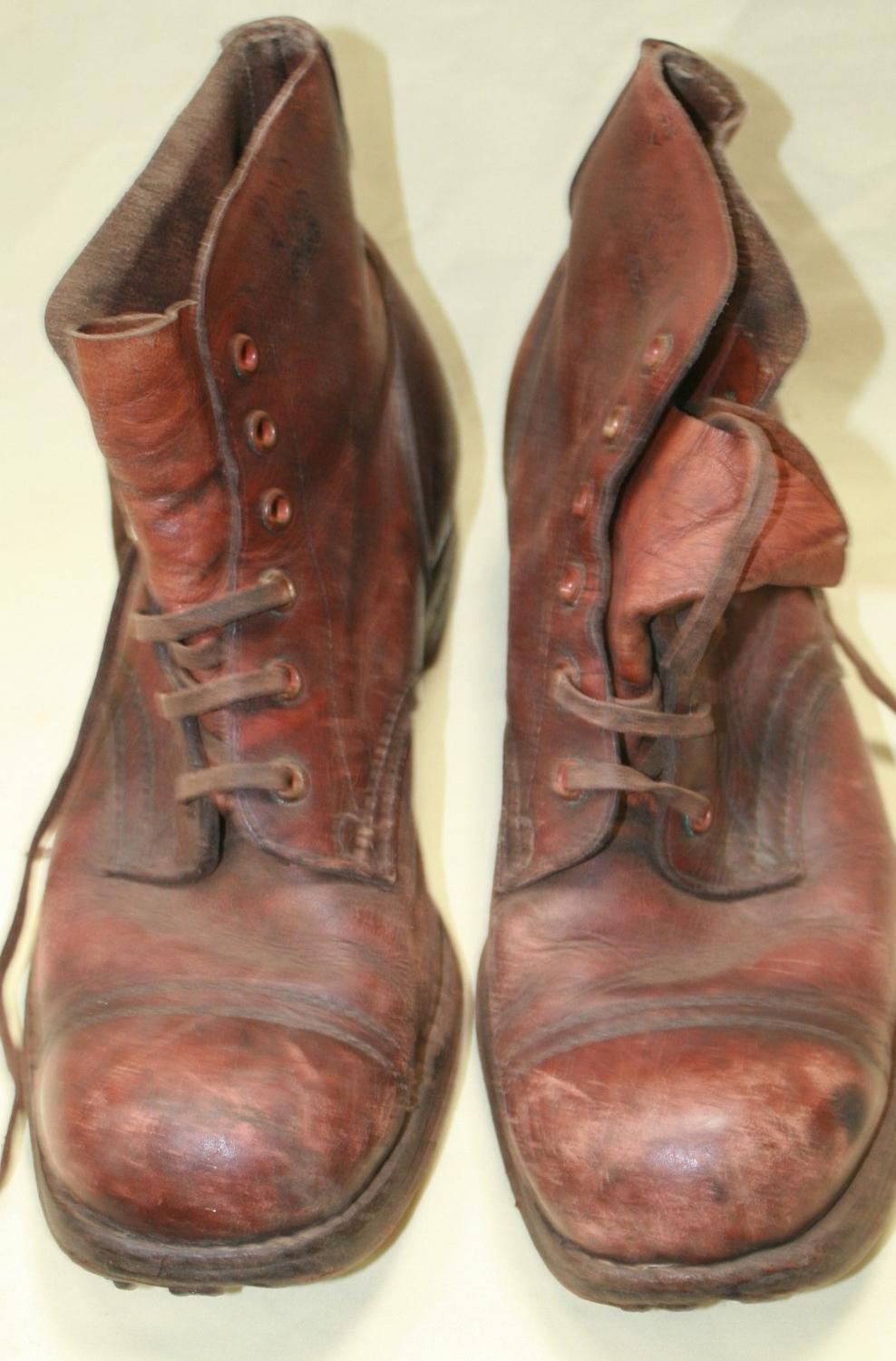 A PAIR OF AUSTRALIAN MADE 1945 DATED JUNGLE BOOTS WELL USED EXAMPLE