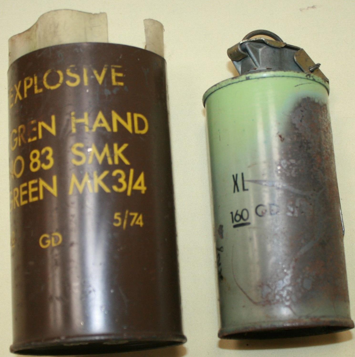 A GREEN USED SMOKE GRENADE 1970'S EXAMPLE WITH ITS TIN