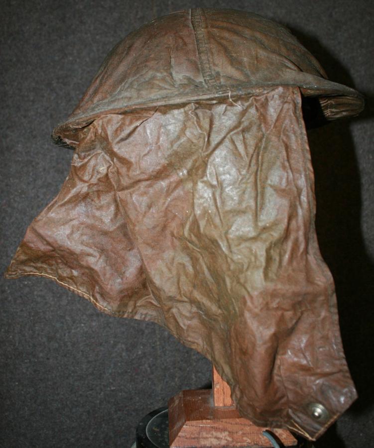 A WWII BRITISH TOMMY HELMET AND GAS HOOD