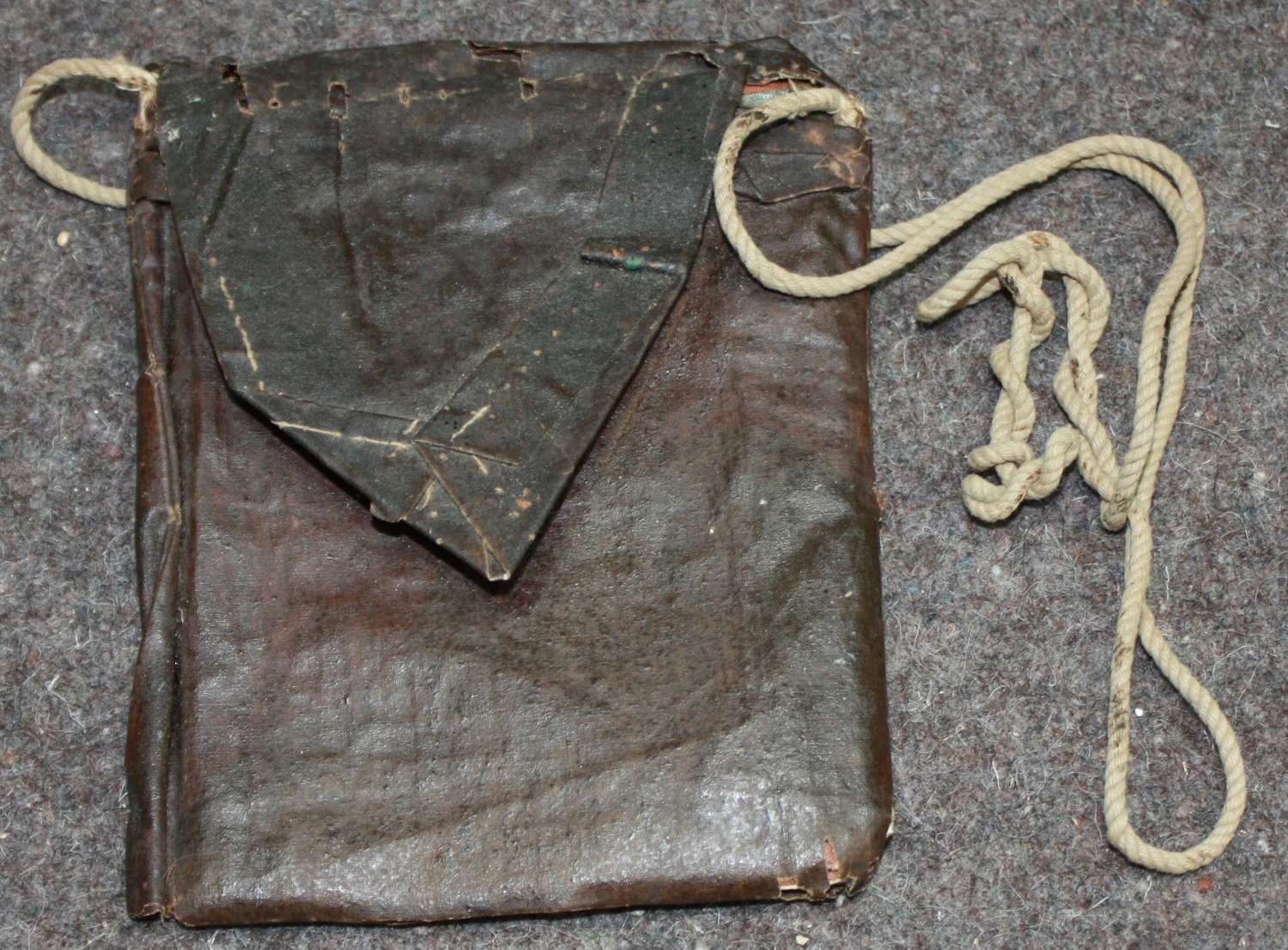 A ROYAL ARMY ORDNANCE CORPS PAY BOOK IN A GAS WALLET