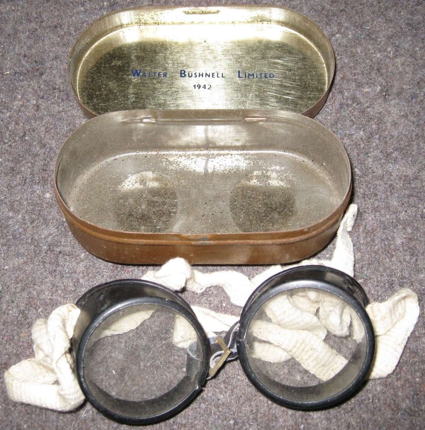 A PAIR OF WWII GOGGLES IN THERE TIN