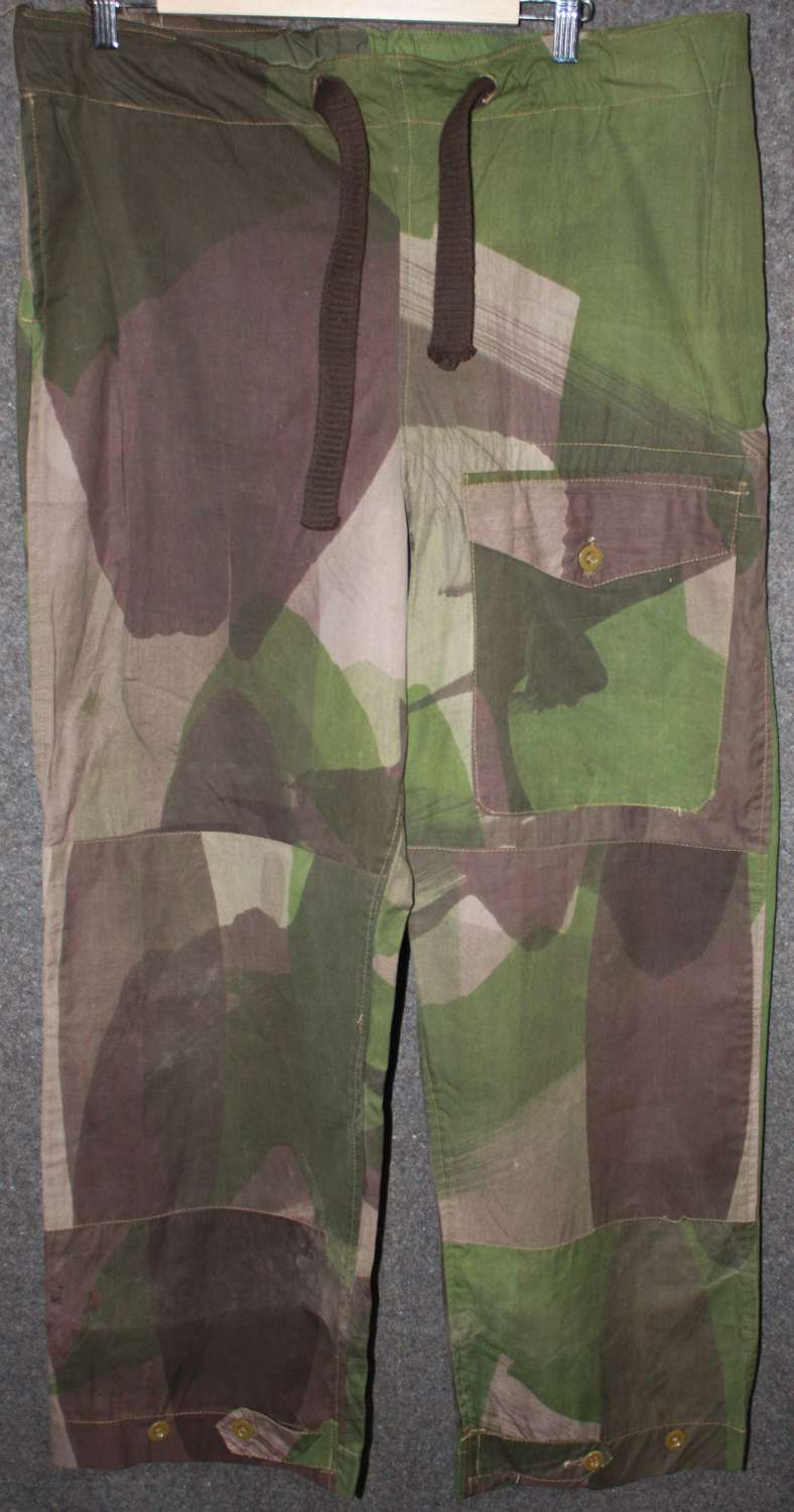 A PAIR OF WWII CAMO WINDPROOF TROUSERS SIZE 2 1943 DATED