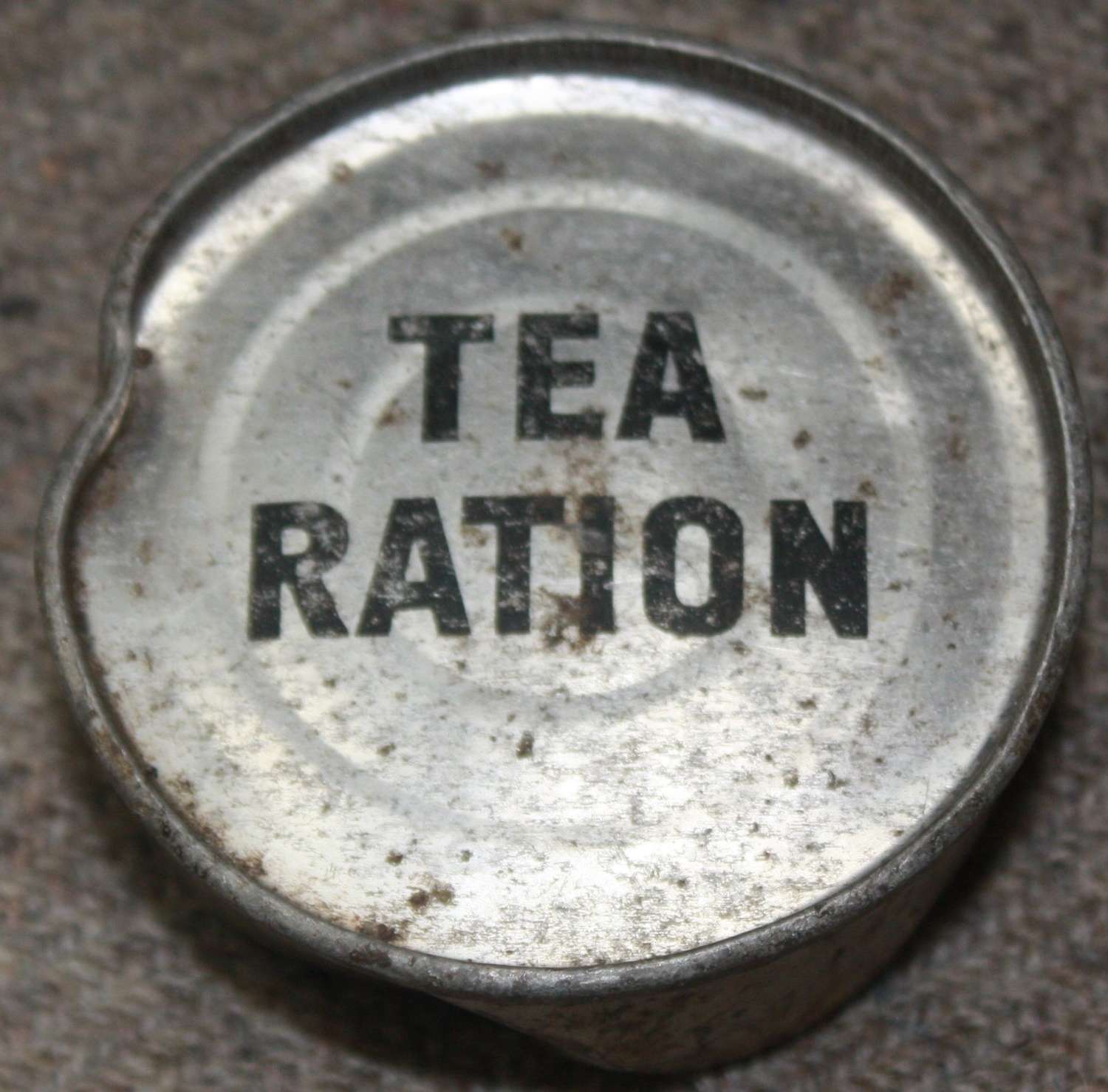 A WWII PERIOD SMALL ROUND TEA RATION TIN WHICH IS FULL