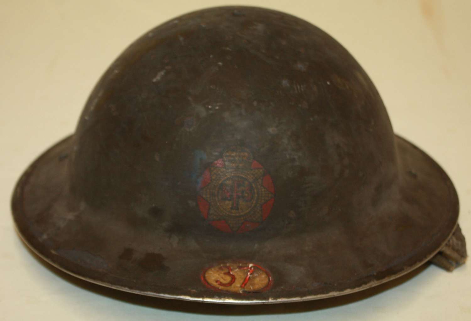 A GOOD SHED FIND WWII NFS FIRE HELMET WITH THE AREA CODE NUMBER 37