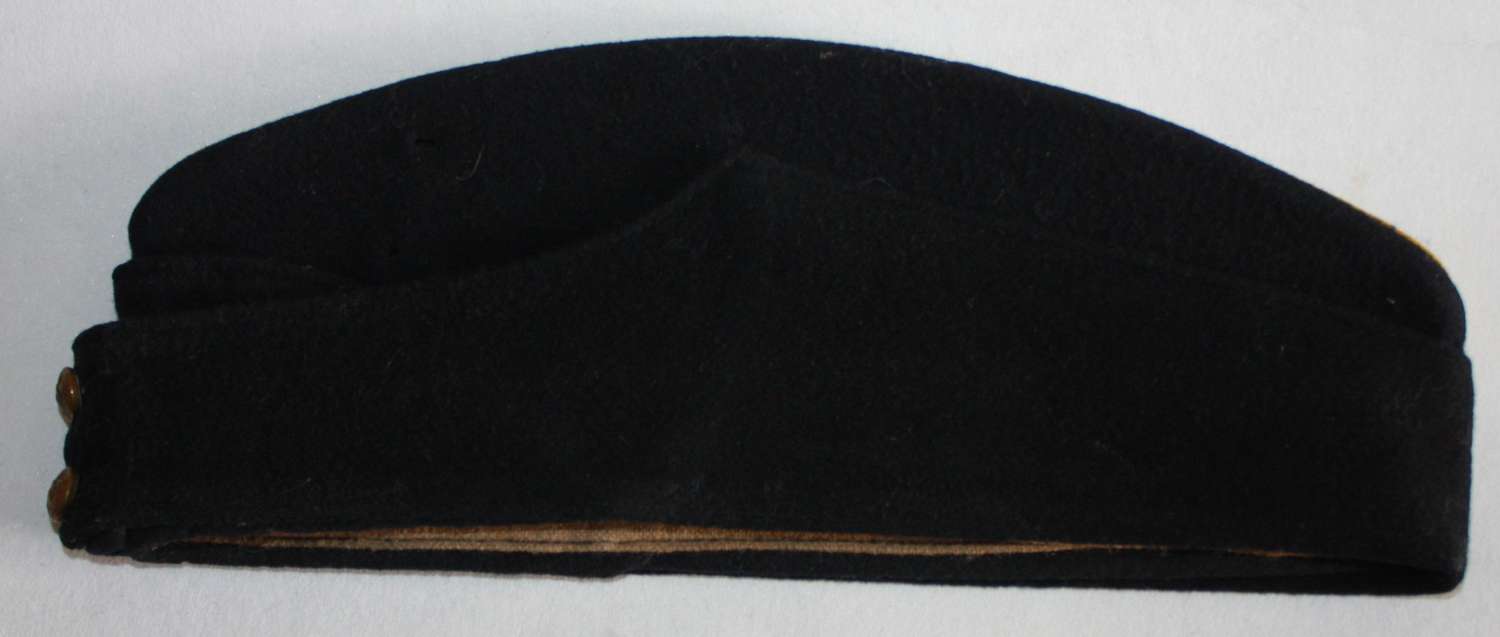 A GOOD WWII PERIOD BLACK SIDE CAP WITH YELLOW PIPING