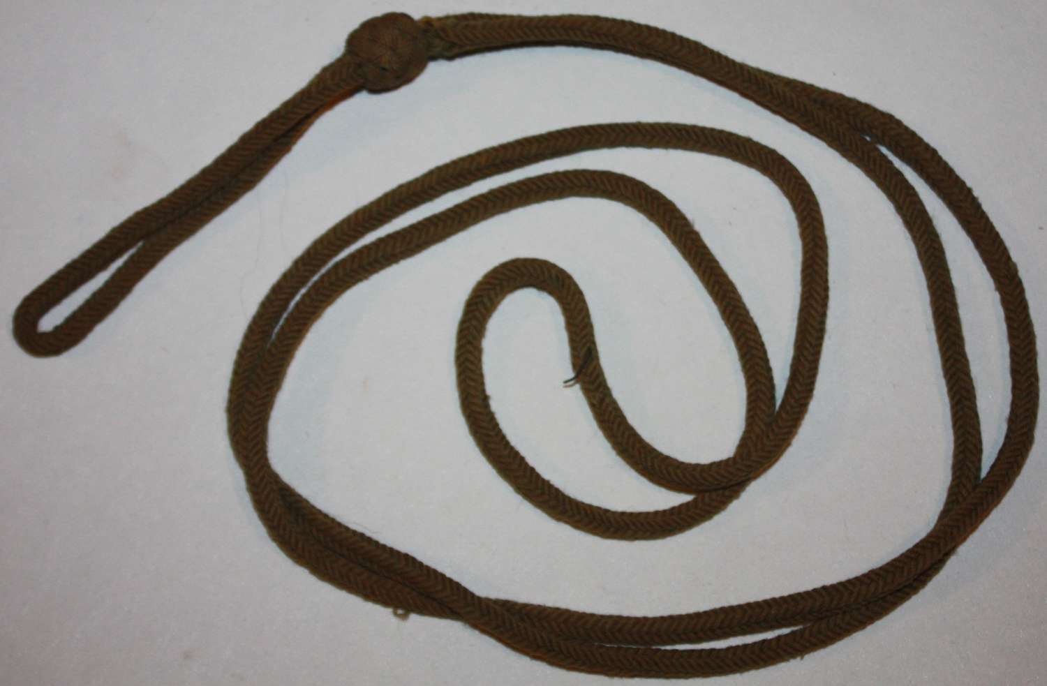 A WWI PERIOD PISTOL LANYARD GOOD USED EXAMPLE MISSING A KNOT