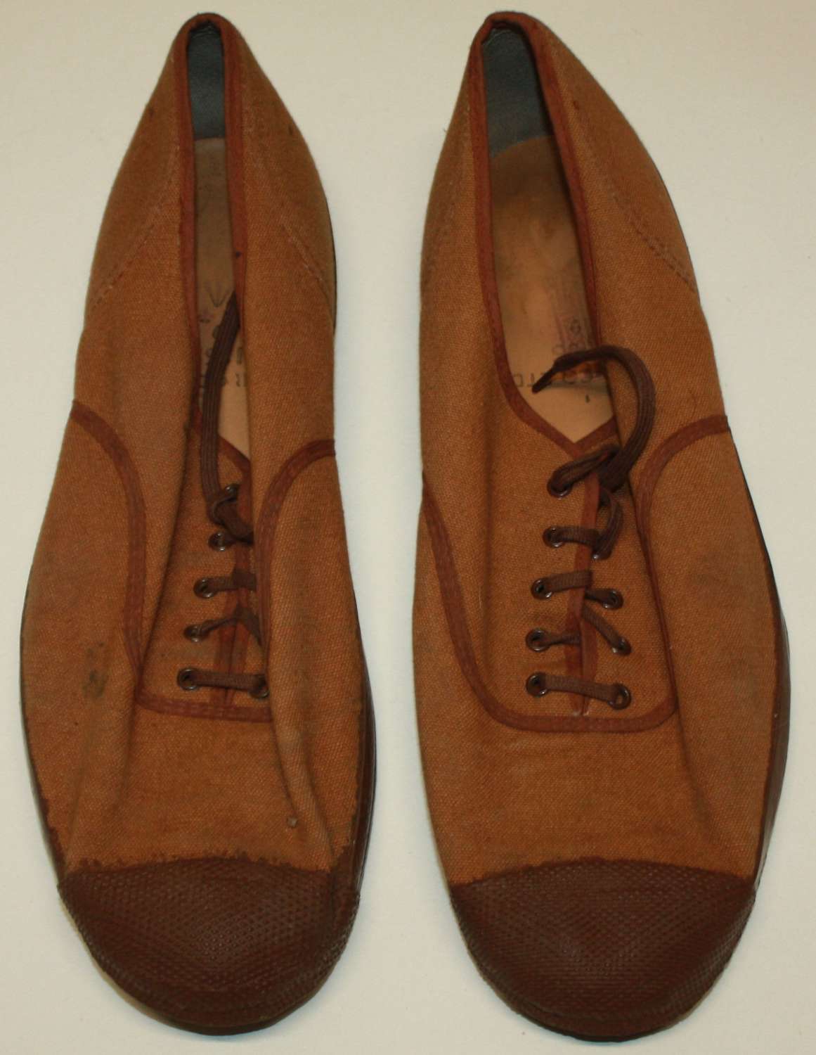 A GOOD PAIR OF THE WWII BRITISH SYLE PLIMSOLES 1955 DATED SIZE 9