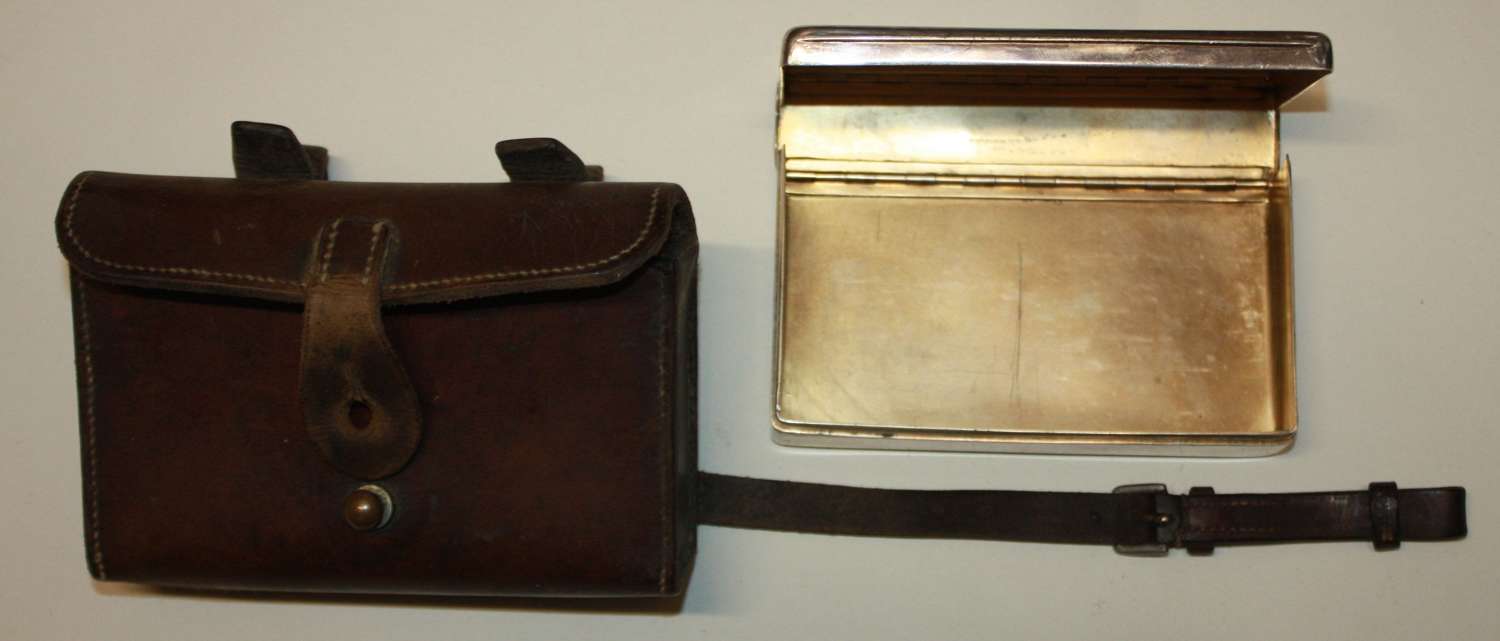 A LEATHER CASED SILVER PLATED SANDWICH TIN