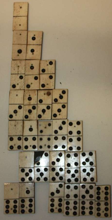 AN INCOMPLETE SET OF BONE AND EBONY HAND MADE DOMINOS