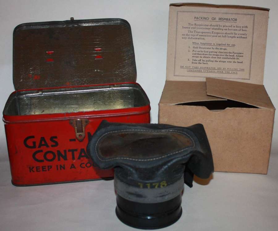 A WWII GAS MASK TIN AND GAS MASK